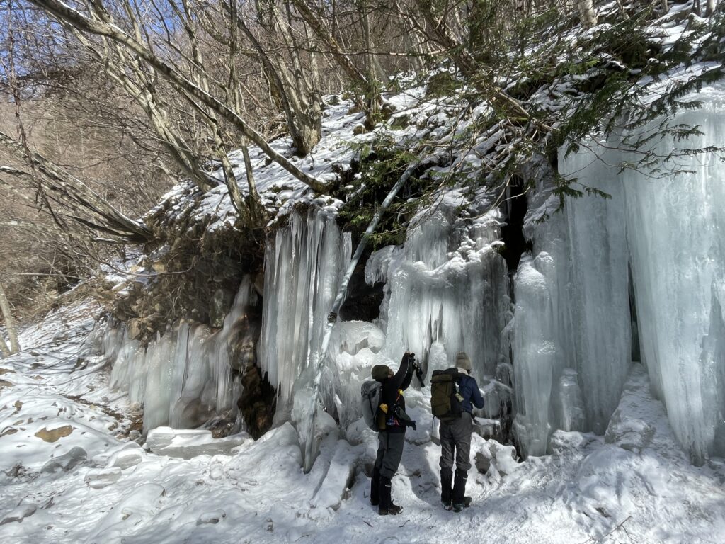 横谷渓谷で氷瀑を楽しむ冬の登山ガイドツアーの様子